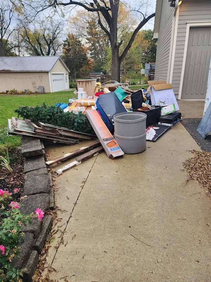 Dumpster being loaded with debris for Residential Dumpster Rental in Cullman
